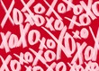 © Elena Uve - Vibrant Valentine's Day wallpaper with XO symbol in pattern against red background. Postcard and banner website for Valentine's Day, wedding and romantic details.