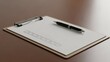 © DENI SETYAWAN - A clipboard with paper & check boxes, a pen rests, on a wooden surface