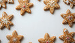 © Natalia - Decorative gingerbread star cookies with icing on a white background for festive holiday treats concept
