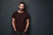 © Oleksandr - Minimalist studio shot of a stylish young man in a brown t-shirt, hands in pockets, grey backdrop