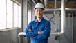 © Vasiliy - Portrait of a smiling Asian male engineer in a factory. Professional technician wearing a white hard hat and blue uniform in an industrial plant. Manufacturing and safety concept