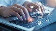 © Tusher - Healthcare Innovation at Work: Hands type on a laptop keyboard, interfacing with a dynamic display of medical icons and data visualizations.