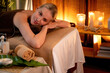 © InfiniteFlow - Caucasian woman customer enjoying relaxing anti-stress spa massage and pampering with beauty skin recreation leisure in warm candle lighting ambient salon spa at luxury resort or hotel. Quiescent