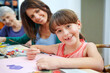 © peopleimages.com - Artwork, family and child at table with homework, help and knowledge in homeschool. Support, portrait and creative people in house with project, guidance and bonding together in childhood development