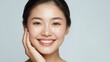 © LimeSky - A young Asian woman has radiant, healthy skin and a cheerful demeanor. She appears younger and has bright skin and teeth. Isolated with space for text