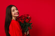 © New Africa - St. Valentine's Day. Beautiful woman with bouquet of roses on red background. Space for text