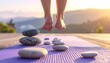 © Sung Hwan Kim - close-up of feet standing on a mat surrounded by rocks during sunset