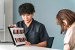 © buritora - A male doctor explaining while showing an endoscopic image during a hospital examination