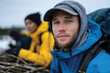 © Milos - A close-up shot of a young male explorer dressed in a blue rain jacket and hat, embodying the spirit of adventure and the thrill of outdoor experiences in a winter setting.