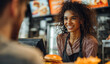 © Andy - Friendly young woman with curly hair wearing a striped shirt and apron smiling while serving food at a cafe counter