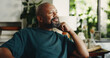 © BuyOutFelix06/peopleimages.com - Relax, smile and reflection with mature black man in home for nostalgia, vision or positive mindset. Thinking, daydreaming and happy person with peace, calm and thoughts in living room on weekend