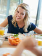 © peopleimages.com - Happy, lunch and woman at table in home for eating, brunch and meal together for bonding. House, family and person with food for nutrition, wellness and health for celebration, gathering or reunion