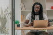 © carballo - young african man with laptop on desk