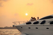 © Jacob Lund - Luxurious yacht sunset cruise: Wealthy family enjoying the experience