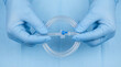 © SUCCESS HOLDINGS - Gloved hands hold IV tubing set. IV tubing with valve and connector for World Health Day, Nurses Day safety training, sterile clinic procedure, closeup healthcare concept, copy space