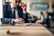 © Jelena - Businessman brainstorming planning ideas in modern office