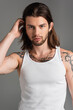 © Bliss - Handsome man striking a confident pose in stylish attire against a minimalist backdrop