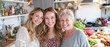 © Kowit - Three women of different ages smile joyfully in a bright kitchen filled with fresh ingredients and cooking items, showcasing a moment of family togetherness.