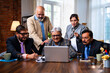 © StockImageFactory - Senior Indian Asian businessmen collaborating with laptop and papers at modern corporate office