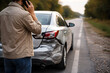 © Image Kit - Person on Phone Standing Next to Damaged Car at Side of Road - Car Accident - Car Crash