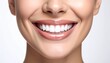 © Adi - Young woman's smiling face with perfect white teeth and glossy lips, close-up portrait in studio lighting with soft focus effect and minimalist background.