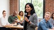 © ryker - Confident woman speaking into microphone during professional workshop with diverse attendees listening and taking notes, conveying engagement and collaborative learning