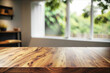 © Ariawan - Wood table top and blurred wall shadow leaves window background - can used for display or montage your products. 3d rendering.