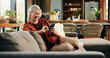 © OnPoint/peopleimages.com - Old woman, phone and laugh on sofa with texting, notification and funny chat in living room at house. Person, smartphone and happy with mobile app, contact and social network on couch at apartment