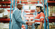 © BuyOutFelix06/peopleimages.com - Logistics, handshake and meeting with people in warehouse for supply chain deal, welcome and thank you. Shipping partnership, shaking hands and b2b export with employees in factory for teamwork