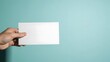 © Md - A hand holding a blank white piece of paper against a blue background
