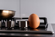 © Lucy Rock - an egg next to a frying pan and stove