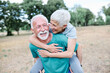 © Lumos sp - Smiling active senior couple having fun  together in the park, active healthy elderly people bonding, older couple happy relationship