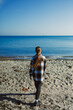 © DSMT - Person walks along sandy beach by the sea during daylight with clear blue sky and calm water in the background on a sunny day