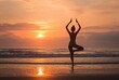 © Kenari - Silhouette of a person practicing yoga on a beach at sunset