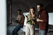 © Novak - Two young startup team members standing in a modern office and looking at a smartphone together, discussing a mobile app or digital marketing strategy.