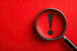 © Alena - Attention sign,Exclamation mark,warning sign concept.,Magnifying glass focus on Hazard warning attention sign icon over yellow background with copyspace