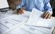 © Lek - asian businessman, legal expert, professional lawyer working on desk reviewing contract document and business contract before provide legal advice to clients
