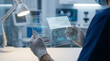 © Aksaka - AI-powered healthcare technology, a medical professional analyzing patient data and diagnostic analytics on a futuristic transparent tablet for medical diagnosis.