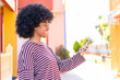 © luismolinero - African American girl using mobile phone at outdoors with happy expression