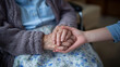 © Maksym - Close-up of elderly hand holding younger hand, care and family bond theme