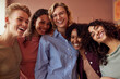 © Flamingo Images - Diverse group of female friends share a joyful moment at a cozy cafe, smiling and embracing in a diverse group