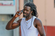© carballo - young man with afro hair or dreadlocks talking on mobile phone on the street