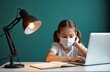 © miss irine - Schoolgirl studies with laptop wearing face mask at home. Girl does homework during online lesson. Student learns at table with computer and notebook near lamp. Pandemic time education.
