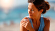 © Kateryna - Faceless young woman applying sun cream sunscreen on tanned shoulder skin protection stock photo sunny day beach SPF lotion UV defense defocused sand background with copy spa