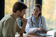 © zinkevych - Female doctor in a lab coat giving prescription to the patient
