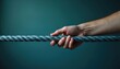 © Vadym - Hand firmly grips thick rope, signifying unity, strength, support. Visual represents connection, trust, reliance in human relationships teamwork. Shows secure hold against strain, conveying