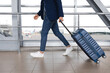 © Prostock-studio - Air Transportation Concept. Unrecognizable man walking with suitcase in airport building, side view of male traveler carrying luggage, going to departure gate in terminal, cropped image, free space