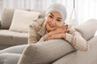 © Pixel-Shot - Young woman after chemotherapy sitting on sofa at home. Brain cancer concept
