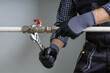 © Sergey - plumber fix leaking pipe at home.