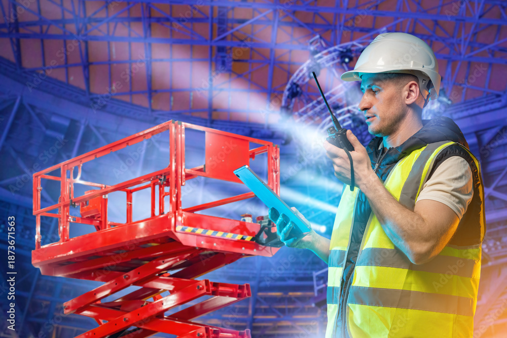 Lift equipment operator manages scissor lift setup using a tablet and ...